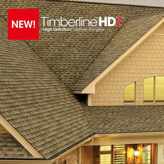 Close-up of a house roof with gray GAF Timberline HDZ 33.33 sq. ft. Per Bundle Laminated High Definition Shingles, beige siding, modern design, and windows. Overlay text reads: NEW! GAF Timberline HDZ Lifetime Warranty Shingles.